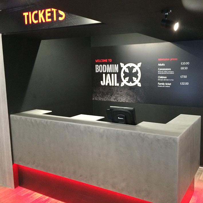 entrance desk for visitor attraction Bodmin Jail with illuminated sign