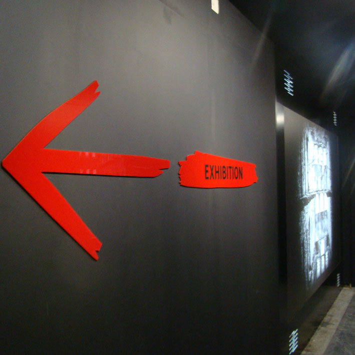 red acrylic exhibition wayfinding sign CNC cut to shape