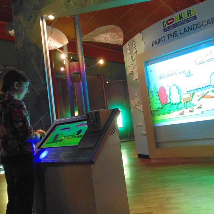 custom museum interactive with coin operated painting wall feature